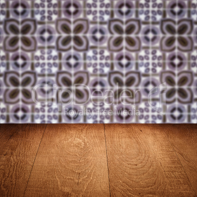 Wood table top and blur vintage ceramic tile pattern wall