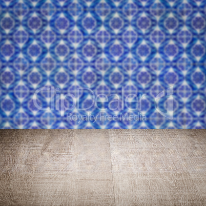 Wood table top and blur vintage ceramic tile pattern wall