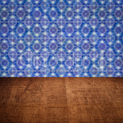 Wood table top and blur vintage ceramic tile pattern wall