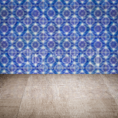 Wood table top and blur vintage ceramic tile pattern wall