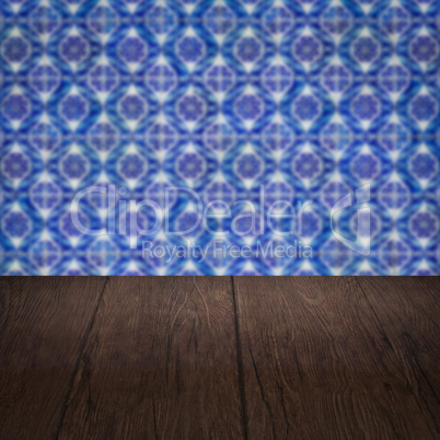 Wood table top and blur vintage ceramic tile pattern wall