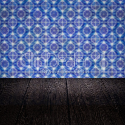 Wood table top and blur vintage ceramic tile pattern wall