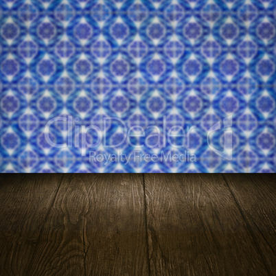 Wood table top and blur vintage ceramic tile pattern wall