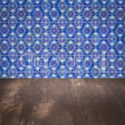 Wood table top and blur vintage ceramic tile pattern wall