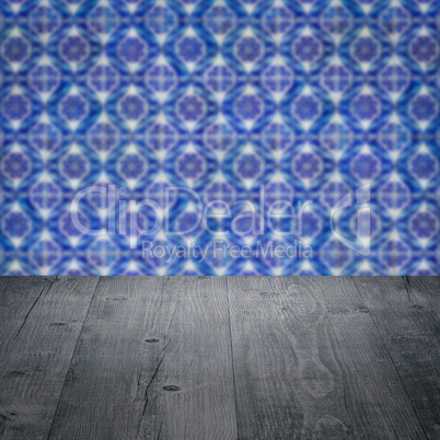 Wood table top and blur vintage ceramic tile pattern wall