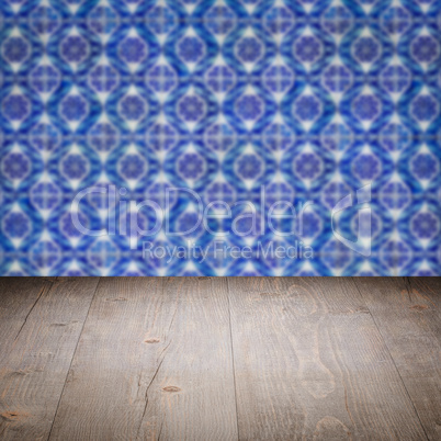 Wood table top and blur vintage ceramic tile pattern wall