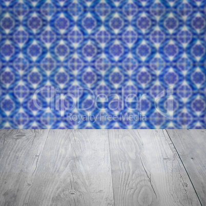 Wood table top and blur vintage ceramic tile pattern wall