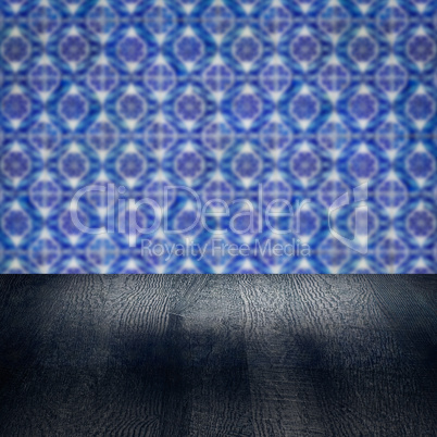 Wood table top and blur vintage ceramic tile pattern wall