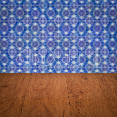 Wood table top and blur vintage ceramic tile pattern wall