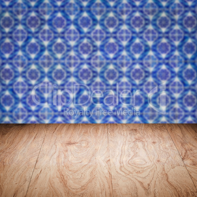 Wood table top and blur vintage ceramic tile pattern wall