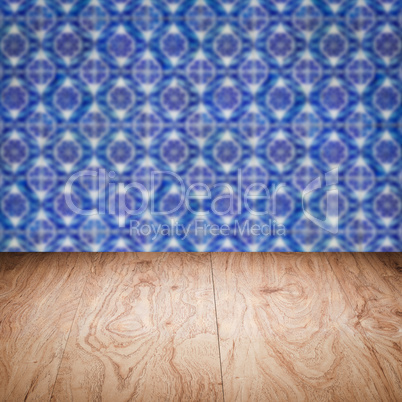 Wood table top and blur vintage ceramic tile pattern wall