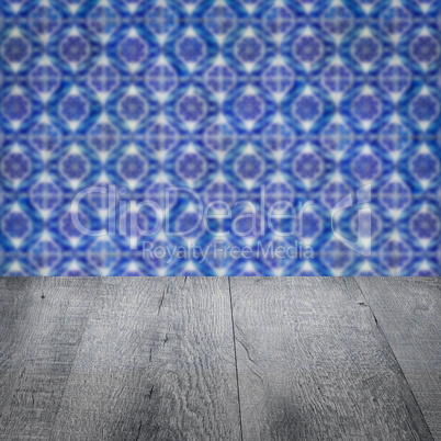 Wood table top and blur vintage ceramic tile pattern wall