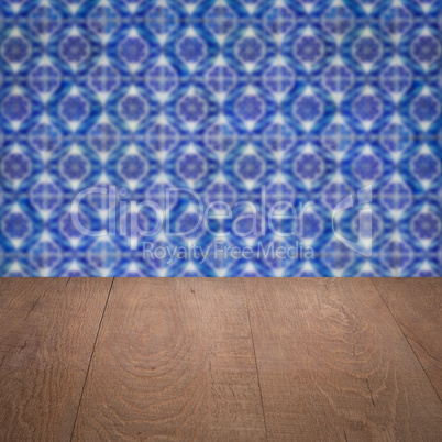 Wood table top and blur vintage ceramic tile pattern wall