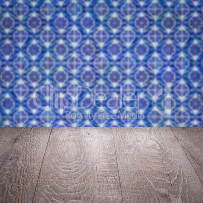 Wood table top and blur vintage ceramic tile pattern wall