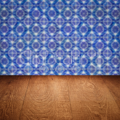 Wood table top and blur vintage ceramic tile pattern wall