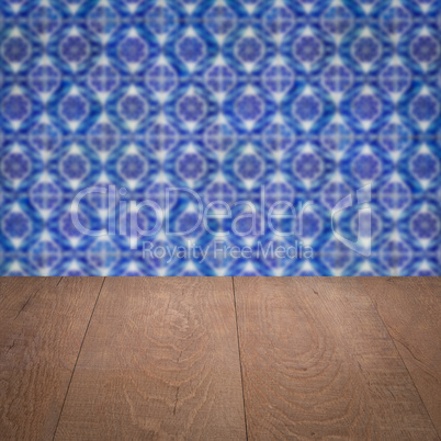 Wood table top and blur vintage ceramic tile pattern wall