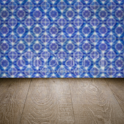 Wood table top and blur vintage ceramic tile pattern wall