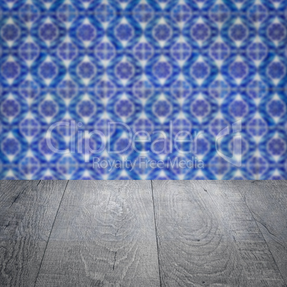 Wood table top and blur vintage ceramic tile pattern wall