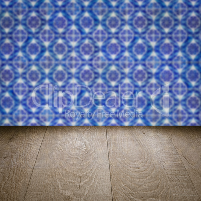 Wood table top and blur vintage ceramic tile pattern wall