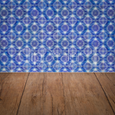 Wood table top and blur vintage ceramic tile pattern wall