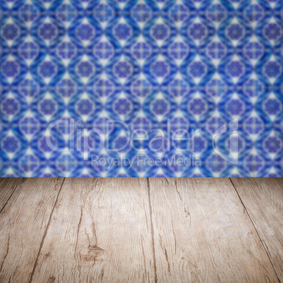 Wood table top and blur vintage ceramic tile pattern wall