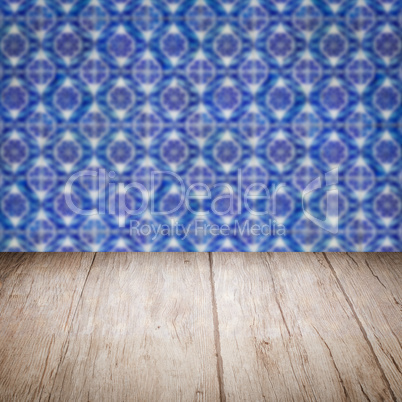 Wood table top and blur vintage ceramic tile pattern wall Wood table top and blur vintage ceramic tile pattern wall
