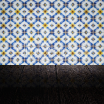 Wood table top and blur vintage ceramic tile pattern wall