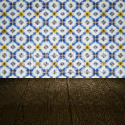 Wood table top and blur vintage ceramic tile pattern wall