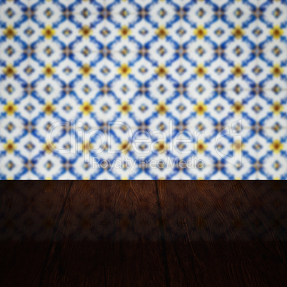 Wood table top and blur vintage ceramic tile pattern wall