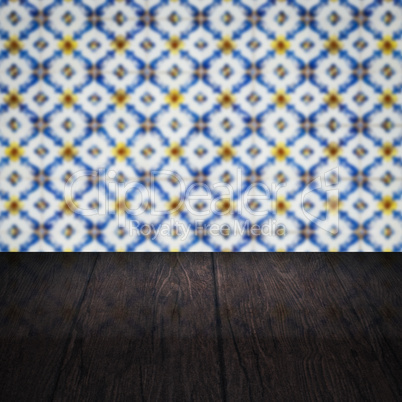 Wood table top and blur vintage ceramic tile pattern wall