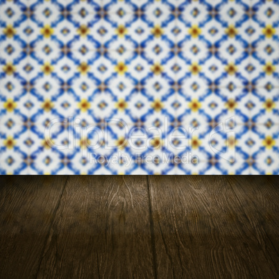 Wood table top and blur vintage ceramic tile pattern wall