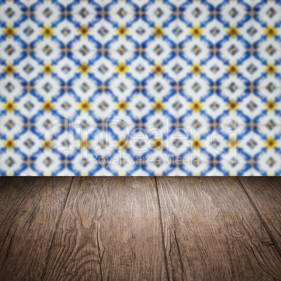 Wood table top and blur vintage ceramic tile pattern wall