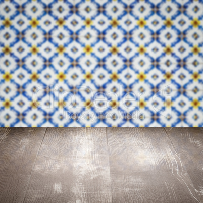 Wood table top and blur vintage ceramic tile pattern wall