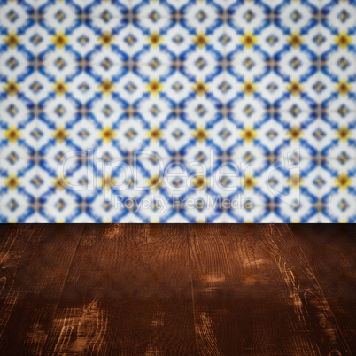 Wood table top and blur vintage ceramic tile pattern wall