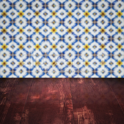 Wood table top and blur vintage ceramic tile pattern wall