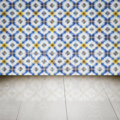 Wood table top and blur vintage ceramic tile pattern wall