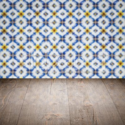 Wood table top and blur vintage ceramic tile pattern wall