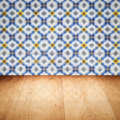 Wood table top and blur vintage ceramic tile pattern wall