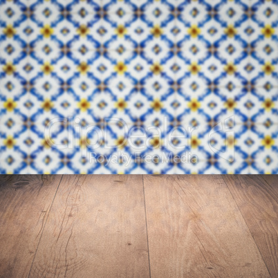 Wood table top and blur vintage ceramic tile pattern wall