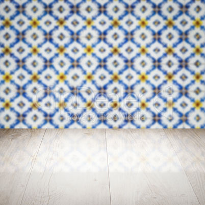 Wood table top and blur vintage ceramic tile pattern wall Wood table top and blur vintage ceramic tile pattern wall