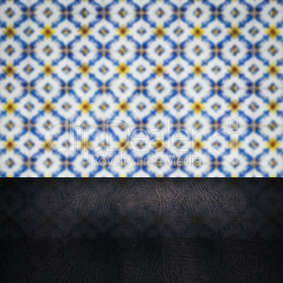 Wood table top and blur vintage ceramic tile pattern wall Wood table top and blur vintage ceramic tile pattern wall