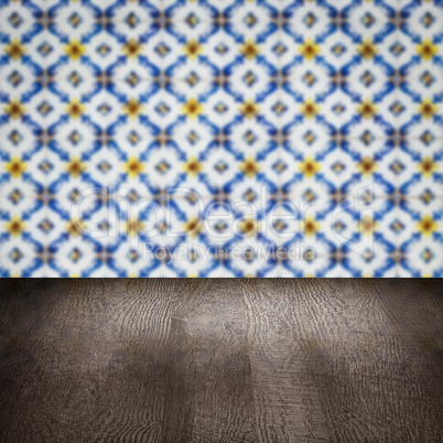 Wood table top and blur vintage ceramic tile pattern wall