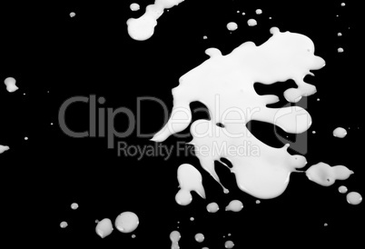 Blots from milk on black background