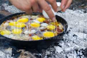 Fried eggs. Cooking on the campfire.