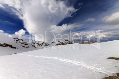 Snowy mountains and sky with clouds