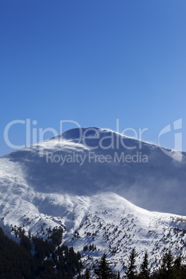 Winter mountains in sunny wind day