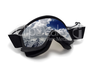 Ski goggles with reflection of cloudy mountains