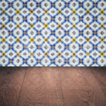 Wood table top and blur vintage ceramic tile pattern wall