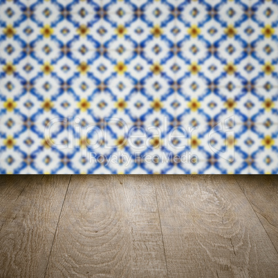 Wood table top and blur vintage ceramic tile pattern wall