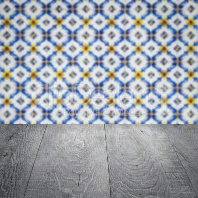 Wood table top and blur vintage ceramic tile pattern wall